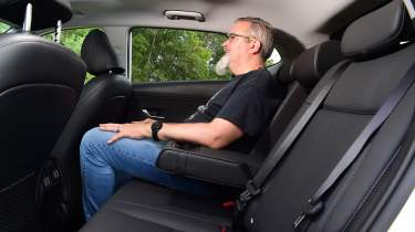 Auto Express senior test editor Dean Gibson sitting in the back seats of the Hyundai Kona